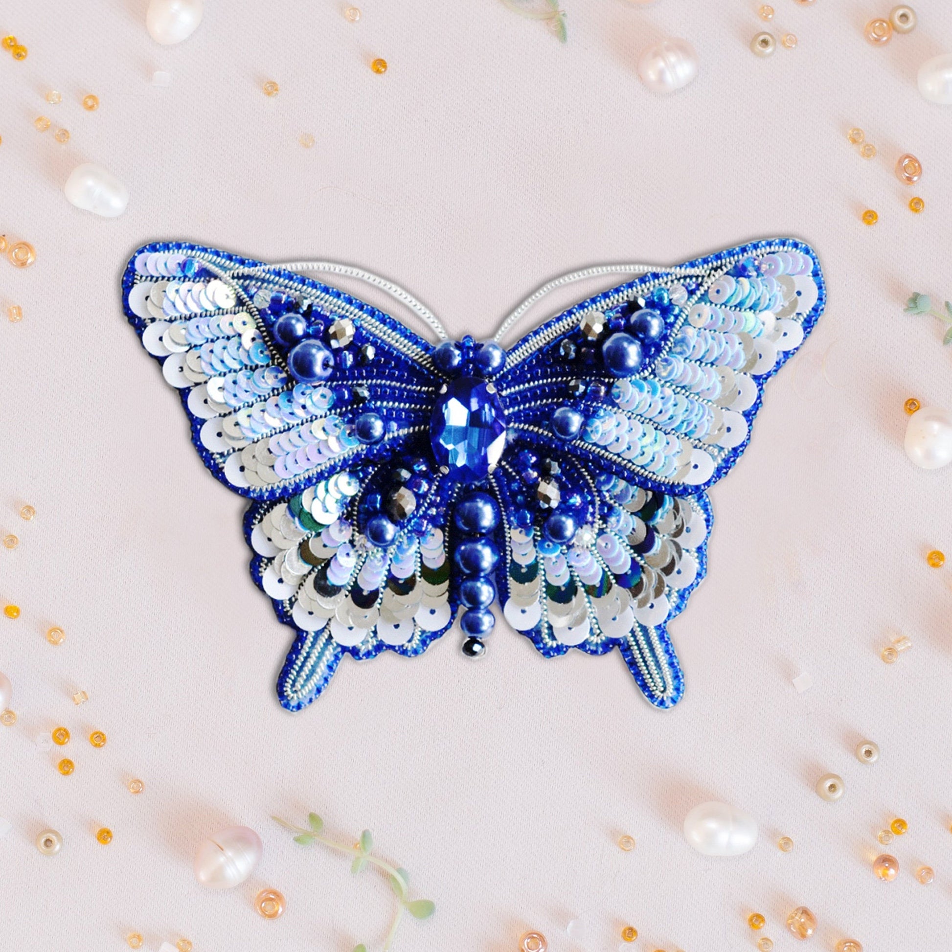 a blue and white butterfly made out of beads