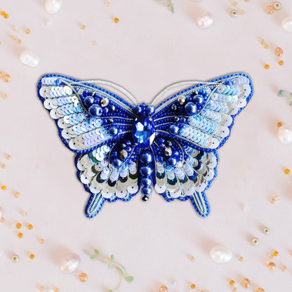a blue and white butterfly made out of beads