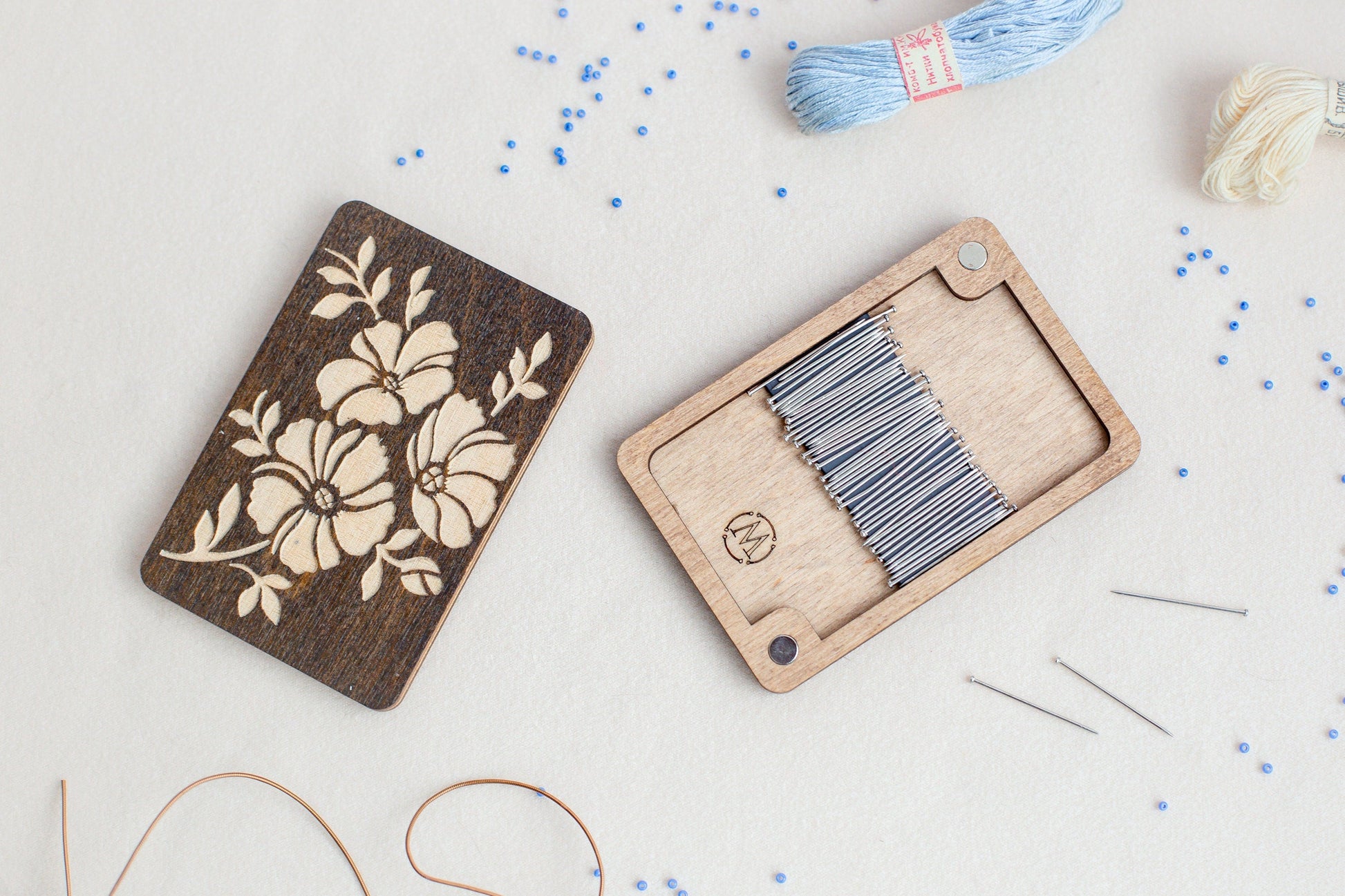 a wooden box with a needle and thread next to it