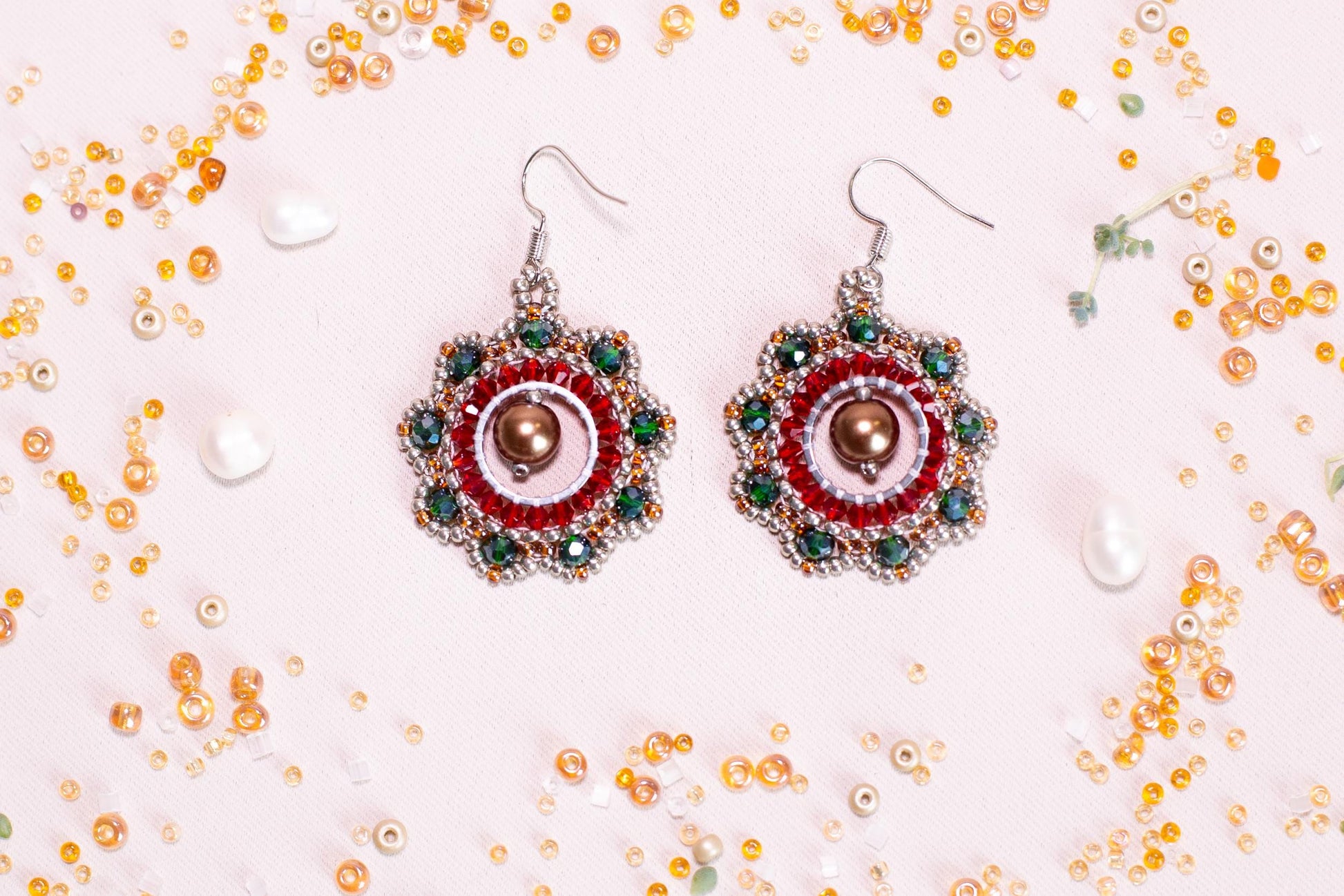 a pair of red and green beaded earrings