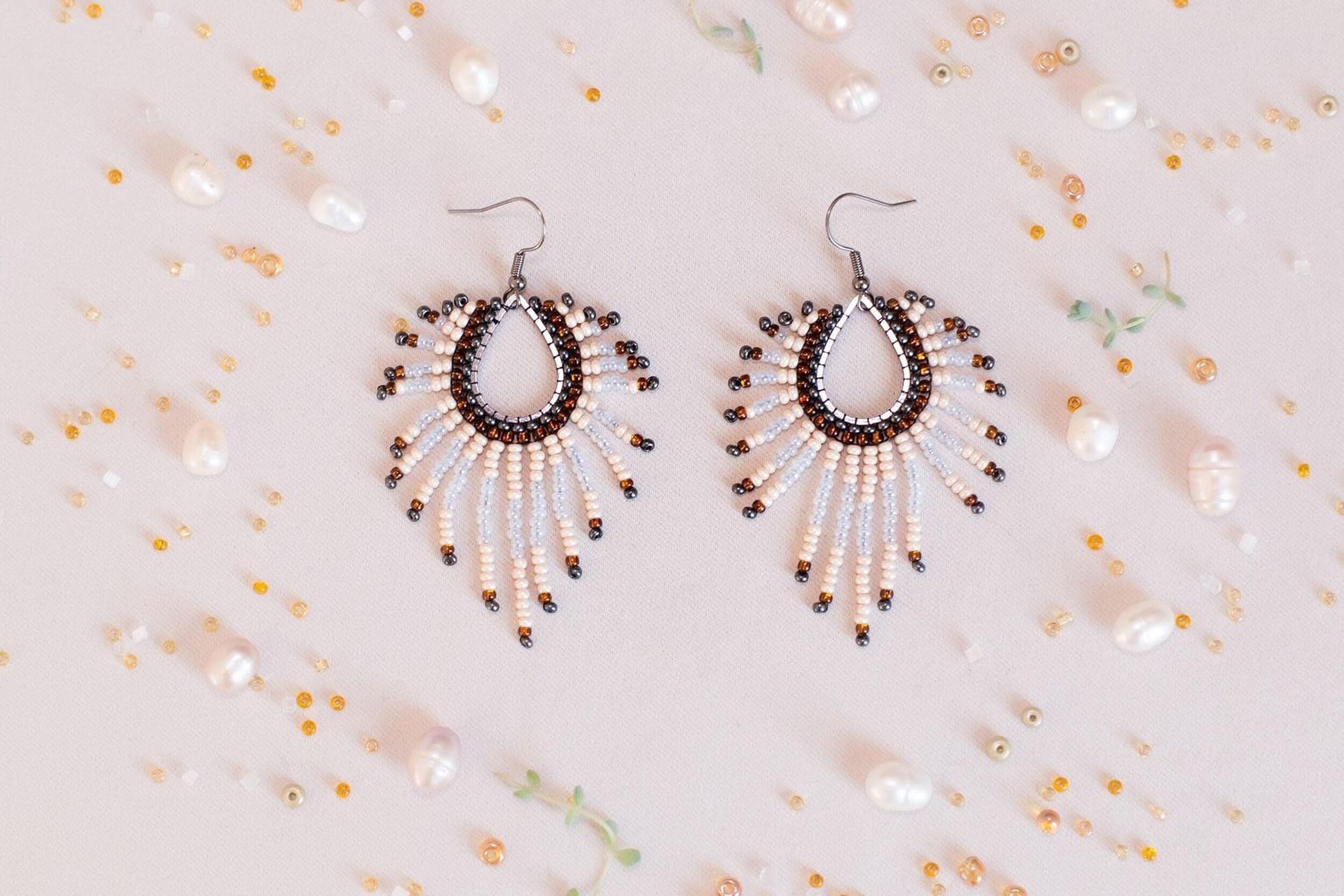 a pair of earrings on a white surface