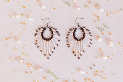 a pair of earrings on a white surface