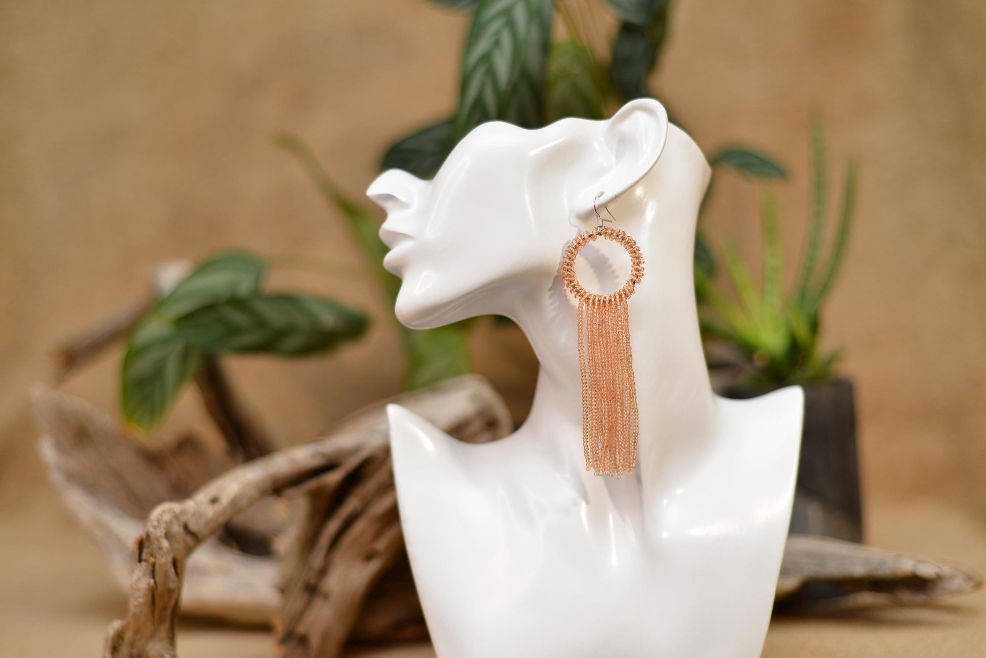 a statue of a woman&#39;s head with a pair of earrings on it