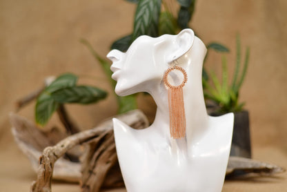 a statue of a woman&#39;s head with a pair of earrings on it