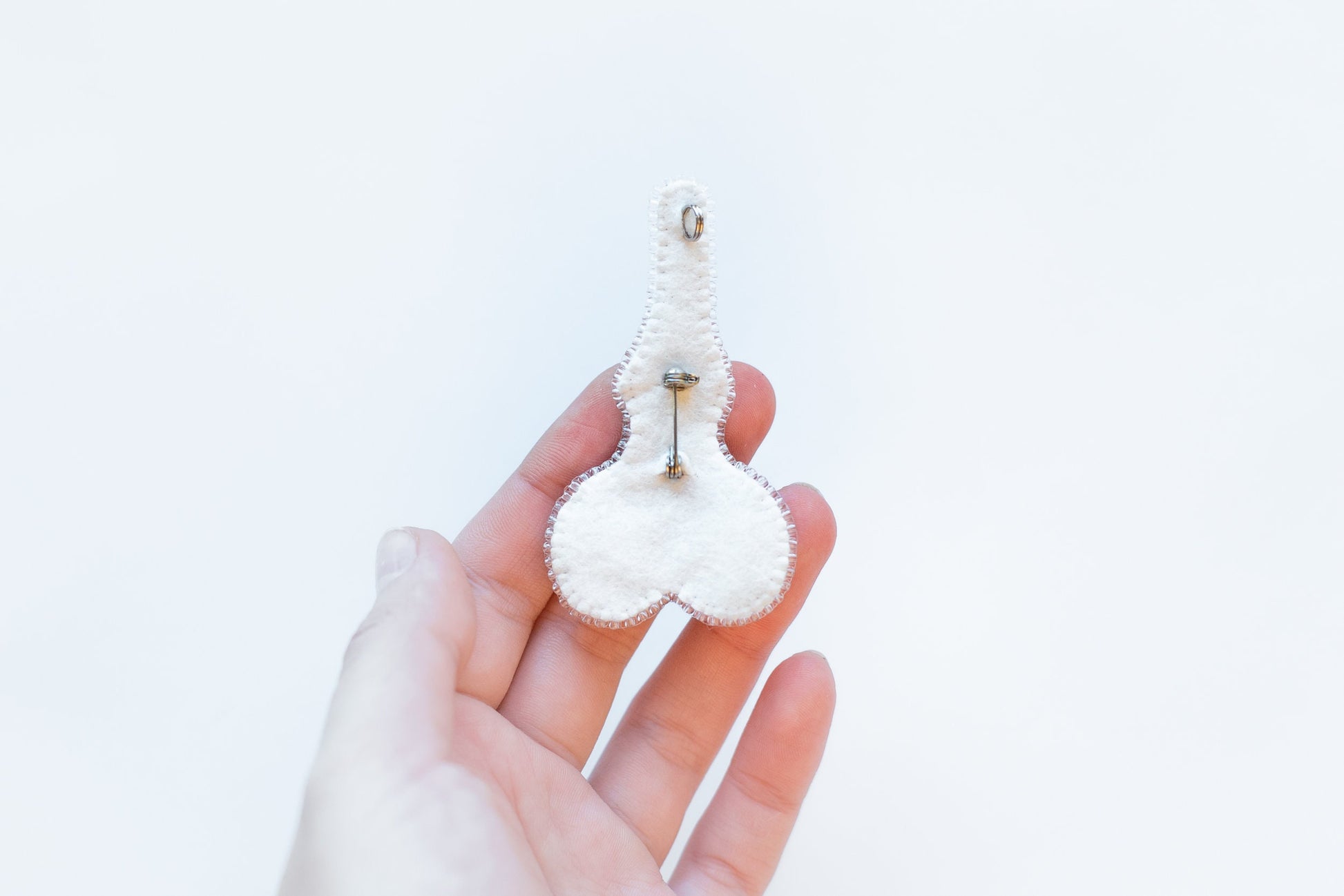 a person holding a small white object in their hand
