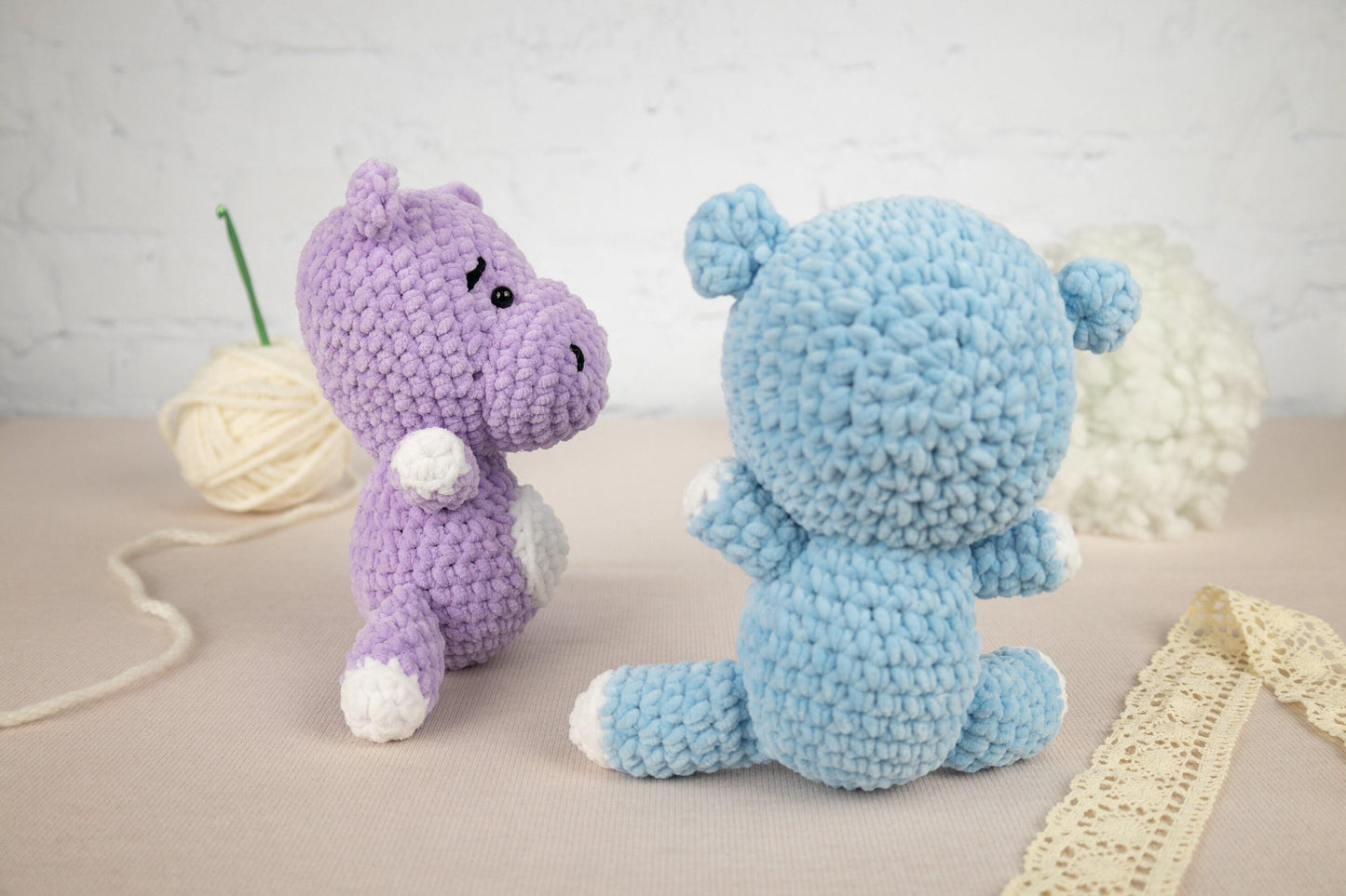 two crocheted stuffed animals sitting next to each other