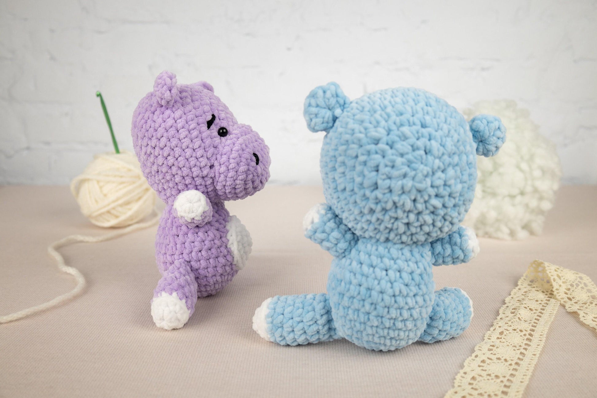 two crocheted stuffed animals sitting next to each other