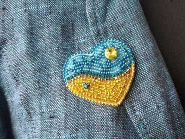 a close up of a blue jacket with a yellow heart on it
