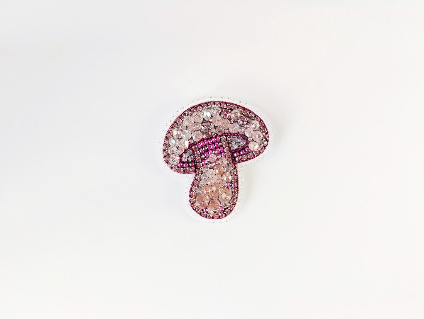 a brooch with a pink and white design on it