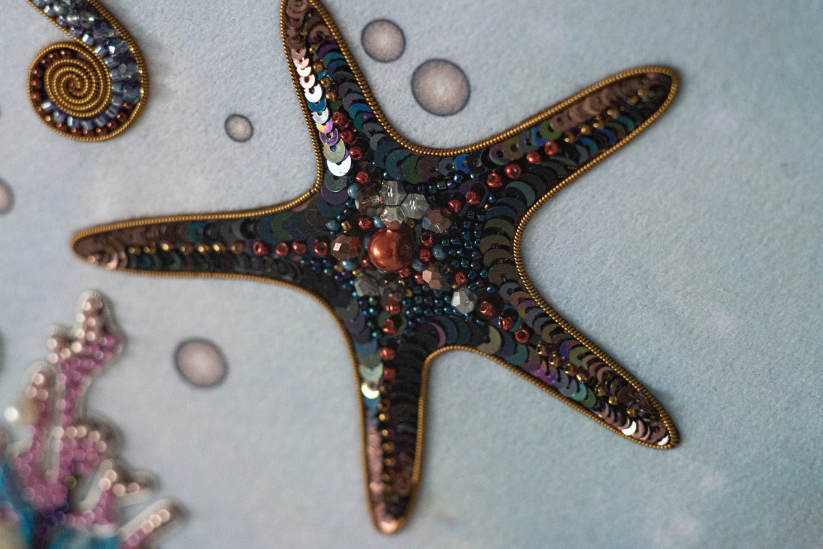 a close-up view of a starfish adorned with colorful beads and sequins, creating a vibrant and intricate design.