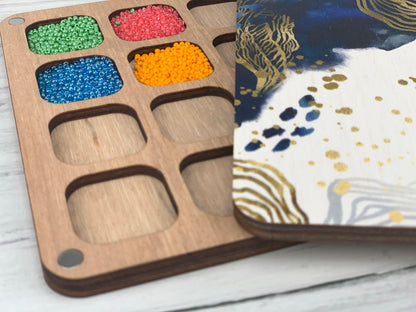 a close up of a tray of beads on a table