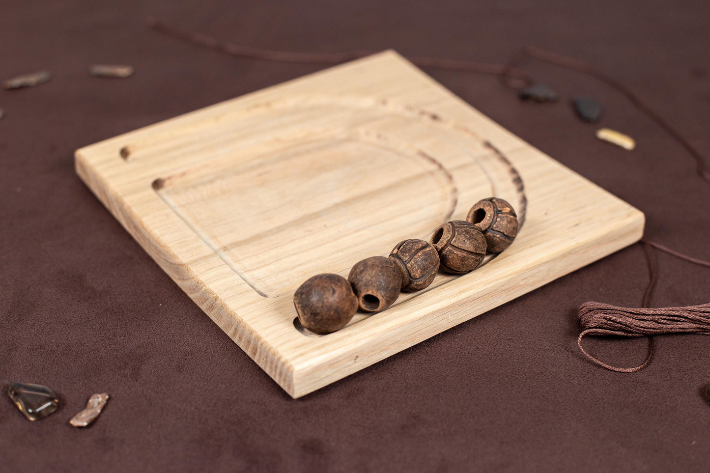 a wooden board with three beads on it