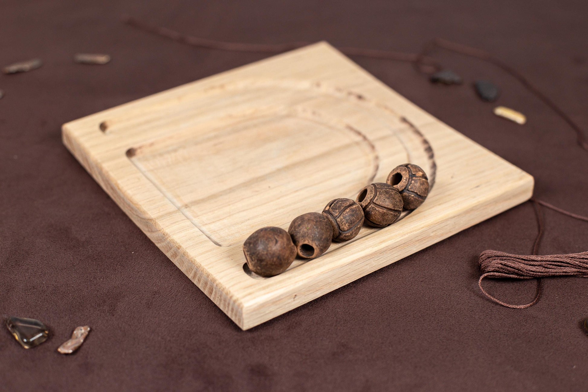 a wooden board with three beads on it