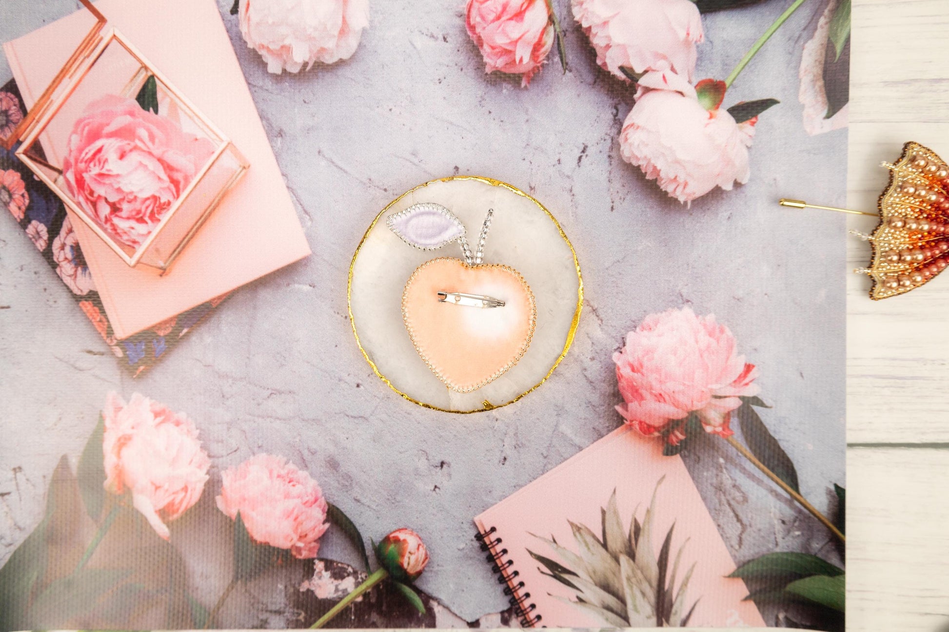 a table topped with pink flowers and a heart shaped object