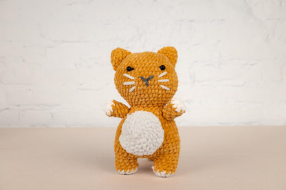 a small crocheted orange and white cat