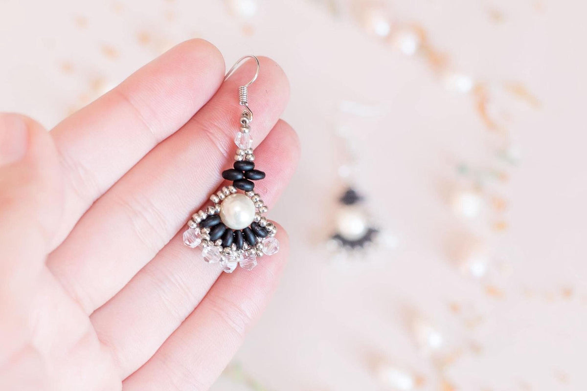 a pair of earrings sitting on top of a table