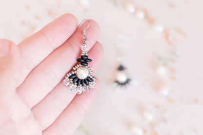 a pair of earrings sitting on top of a table