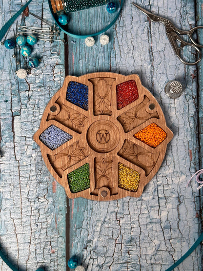 a wooden board with beads and a pair of scissors