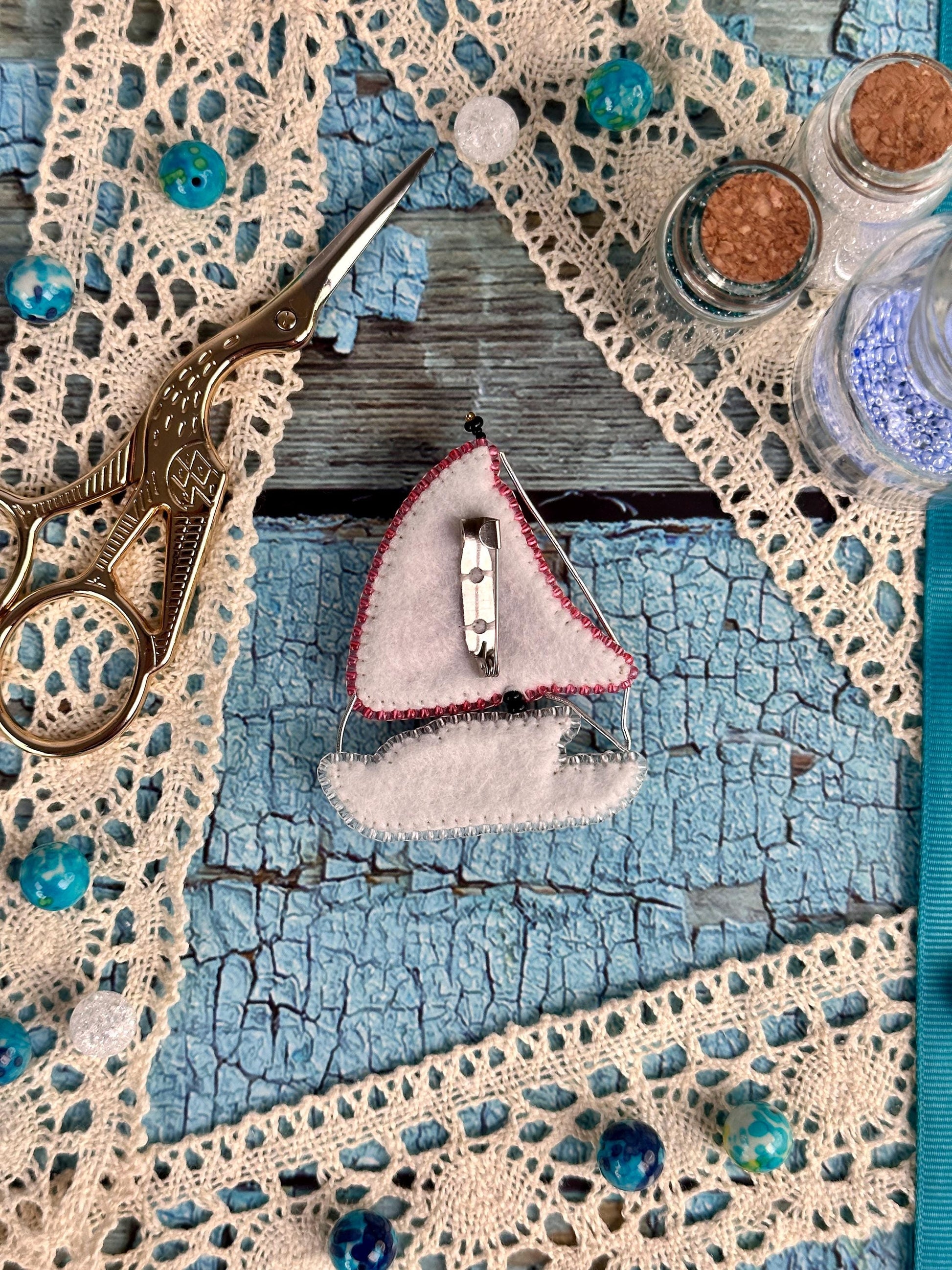 a pair of scissors sitting on top of a piece of cloth