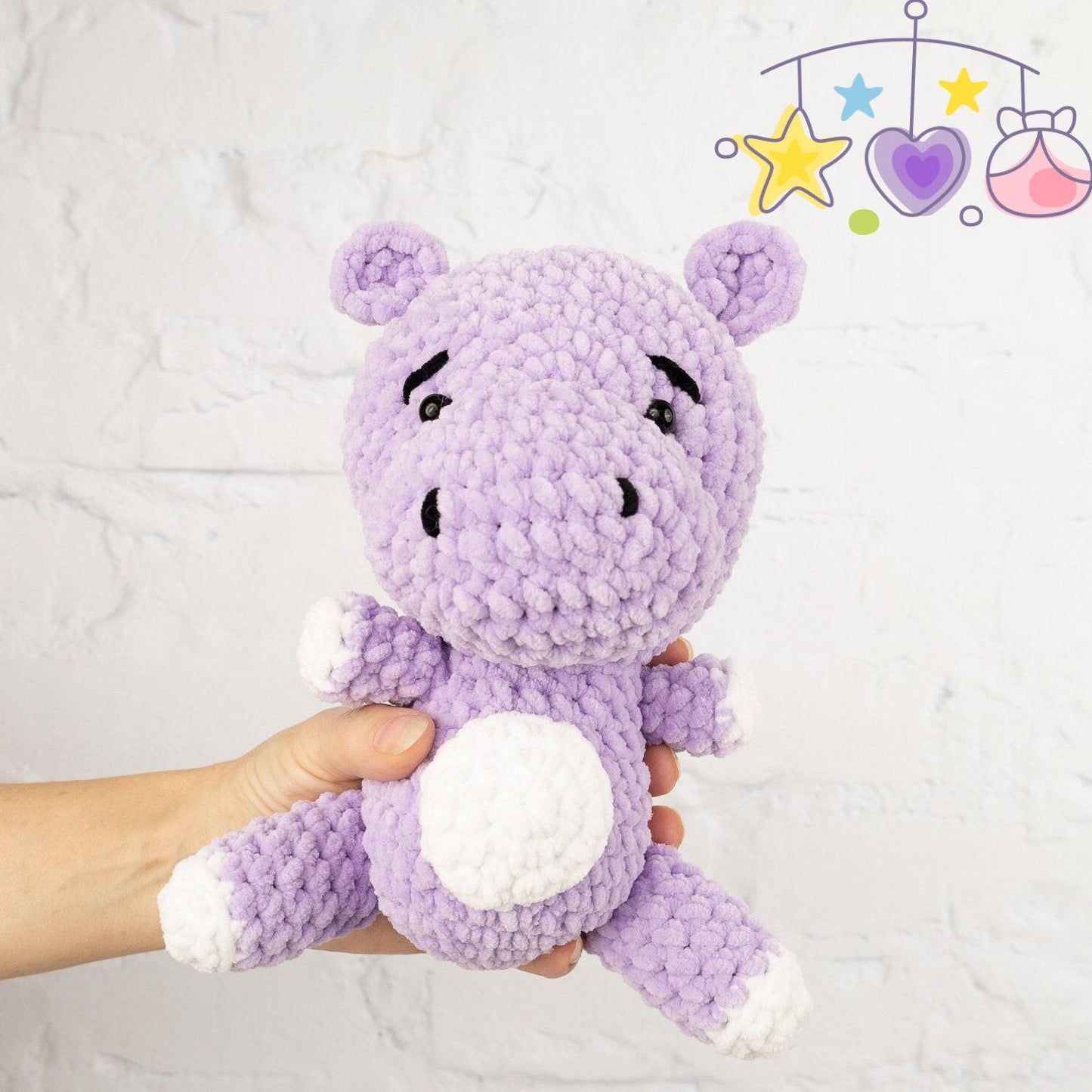 a crocheted stuffed animal sitting next to a ball of yarn