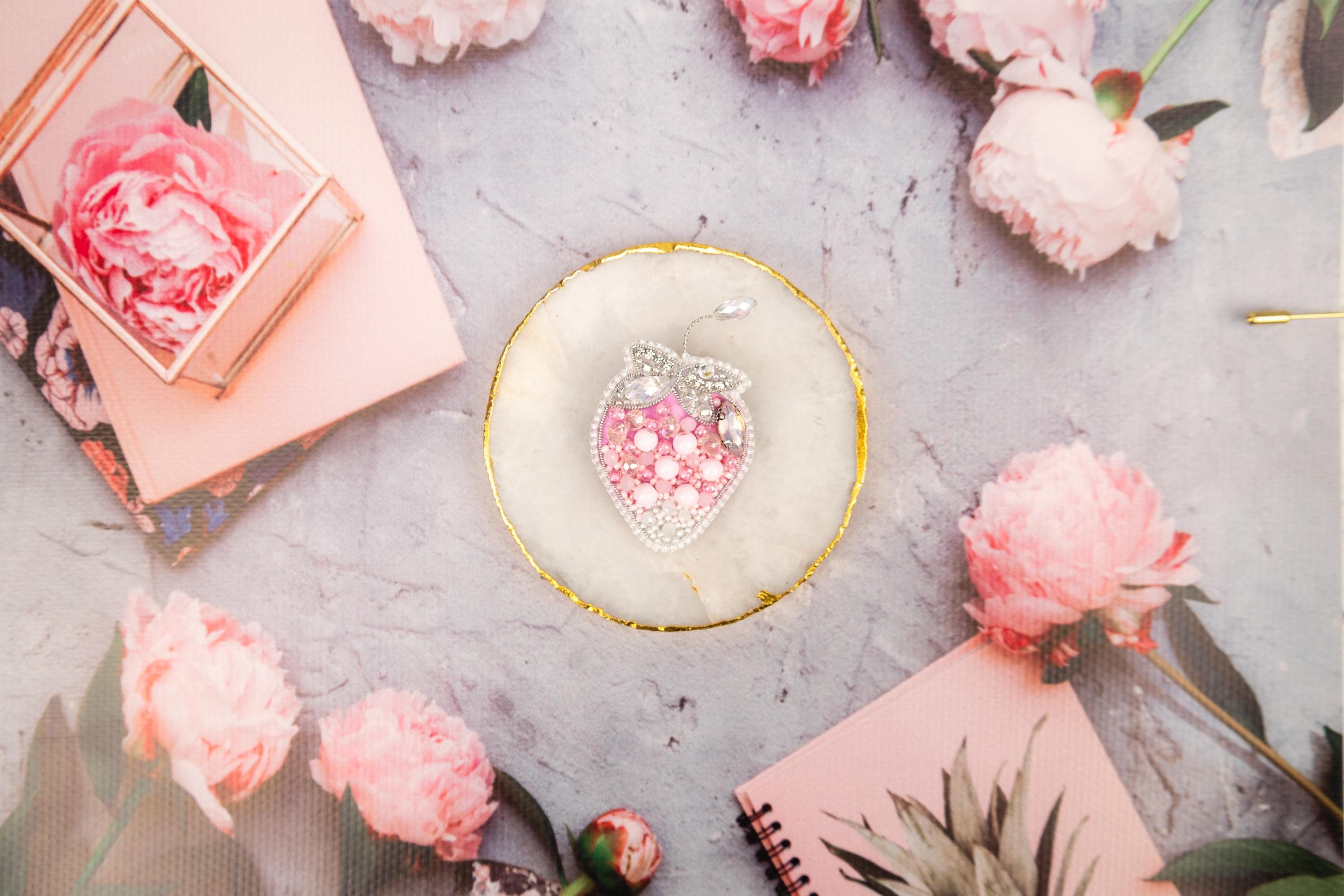 a table topped with pink flowers and pictures
