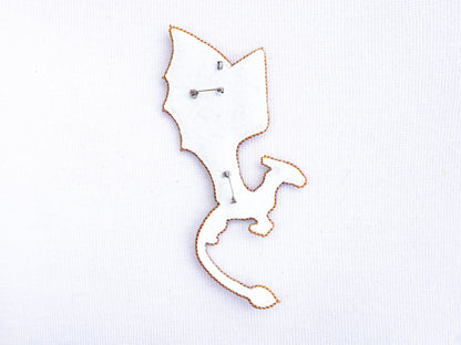 a close up of a metal object on a white surface