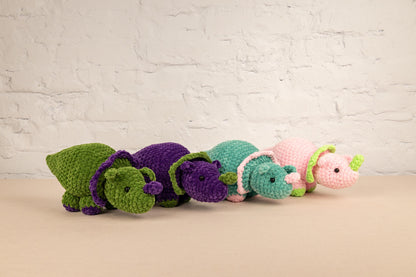 a row of crocheted stuffed animals sitting next to each other