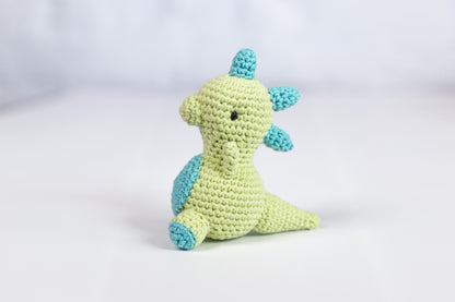 a crocheted stuffed animal sitting on a white surface