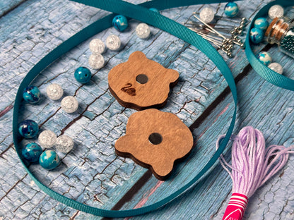 a pair of wooden buttons sitting on top of a table