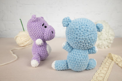 two crocheted stuffed animals sitting next to each other