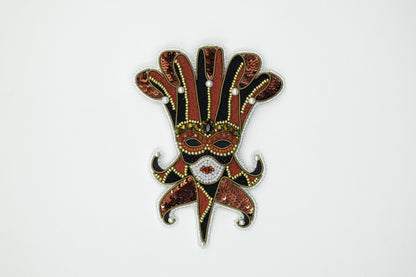 a red and black mask on a white background