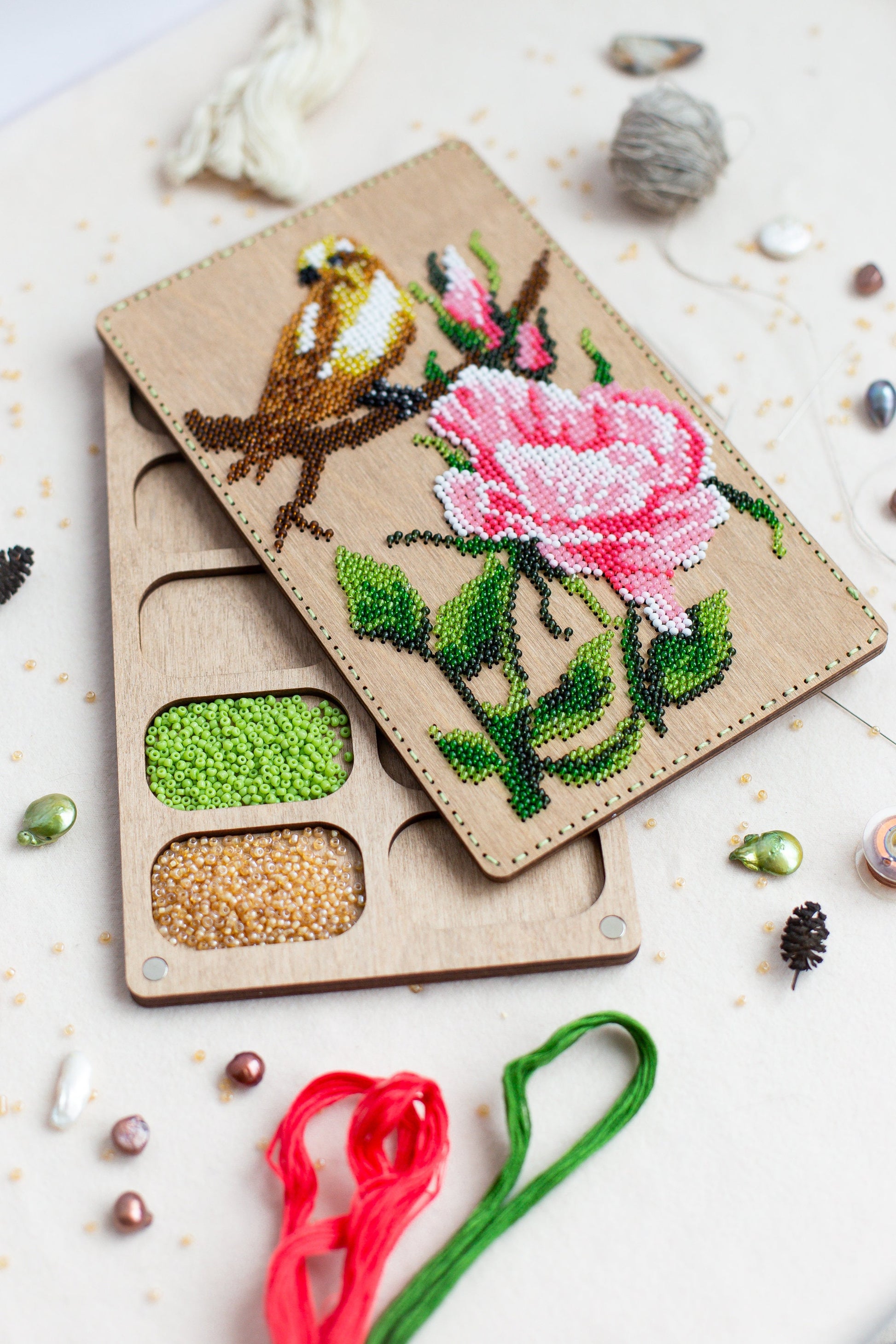 a pair of scissors sitting next to a piece of wood