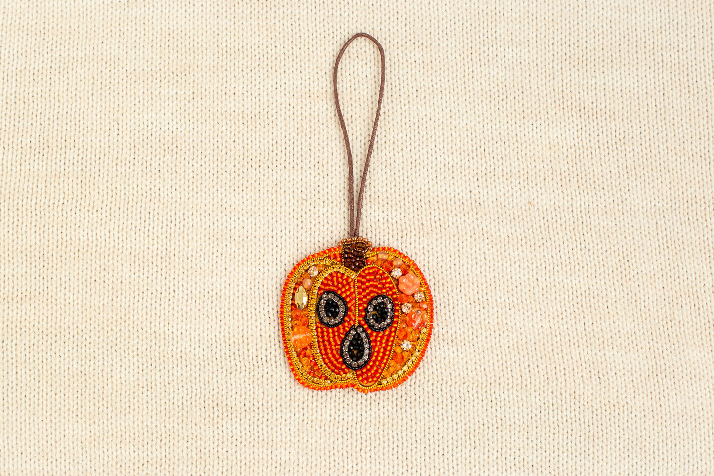 a beaded ornament hanging from a cord