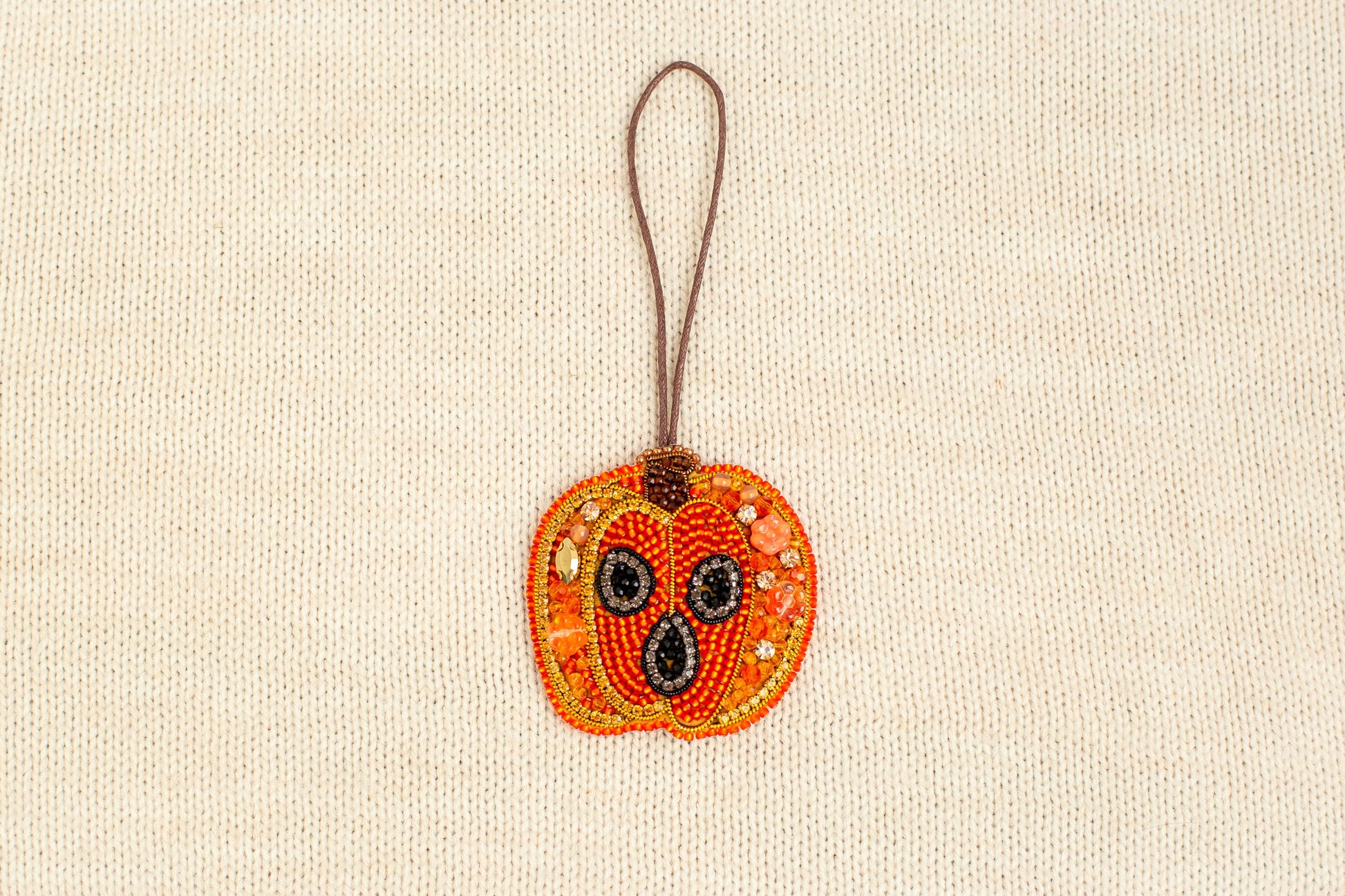 a beaded ornament hanging from a cord