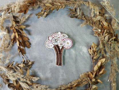 a picture of a brooch with a tree on it