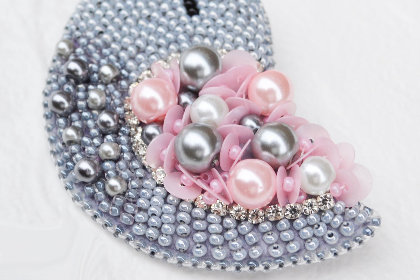 a purse with pearls and flowers on it