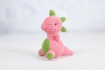 a crocheted pink and green stuffed animal