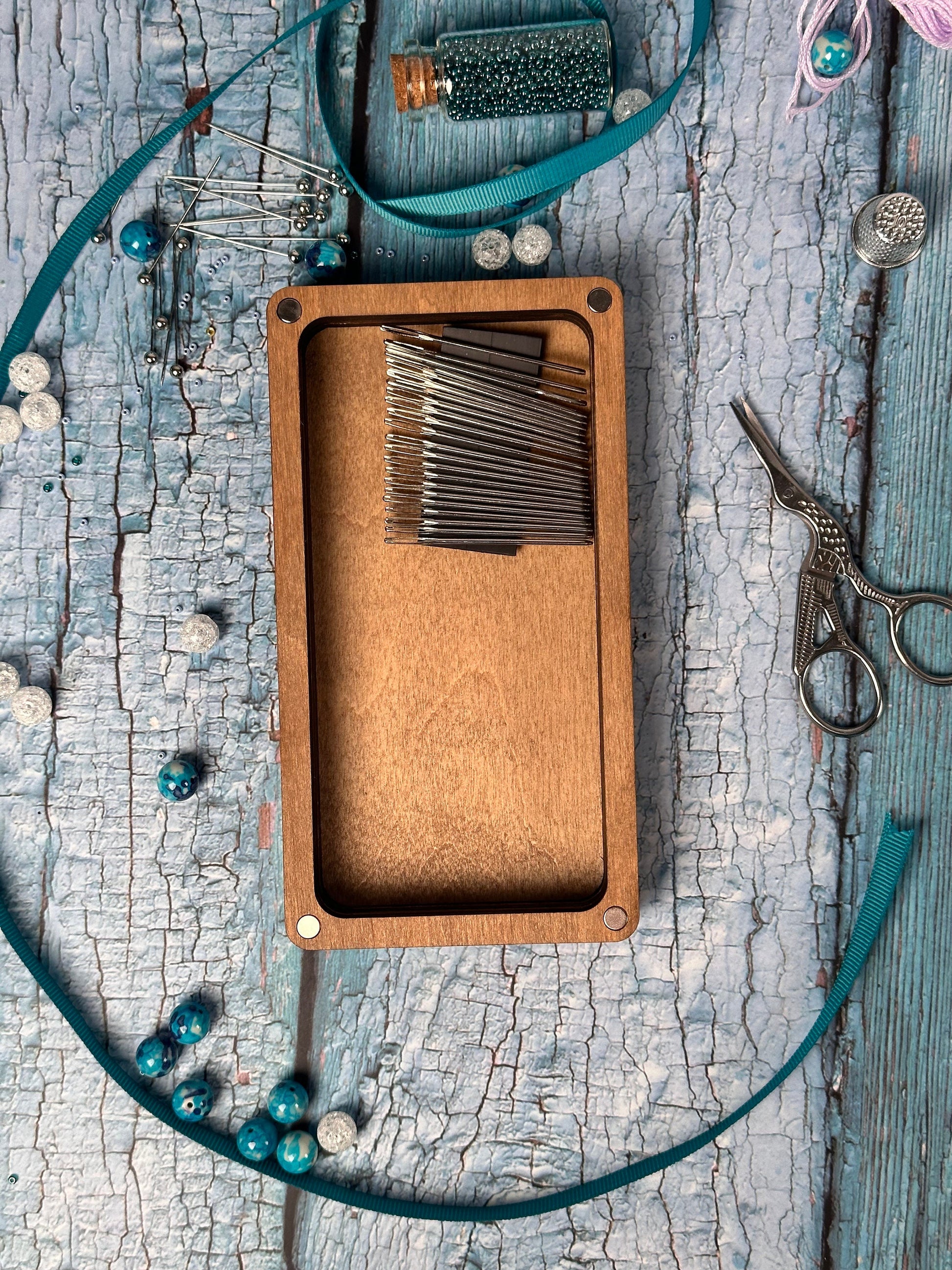 a close up of a wooden box with scissors