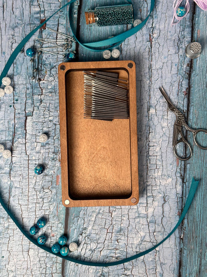 a close up of a wooden box with scissors