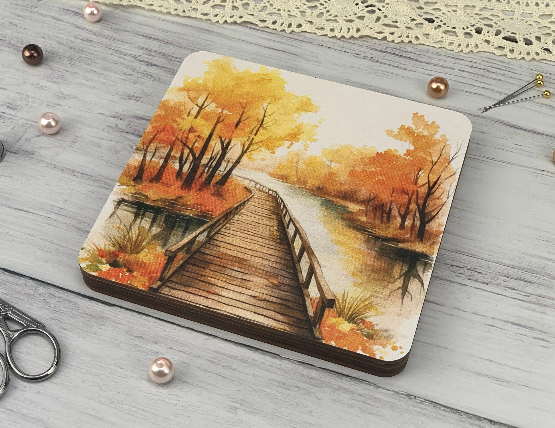 a coaster with a painting of a bridge