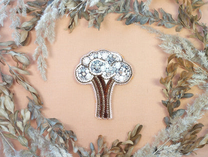 a brooch with a bouquet of flowers on it