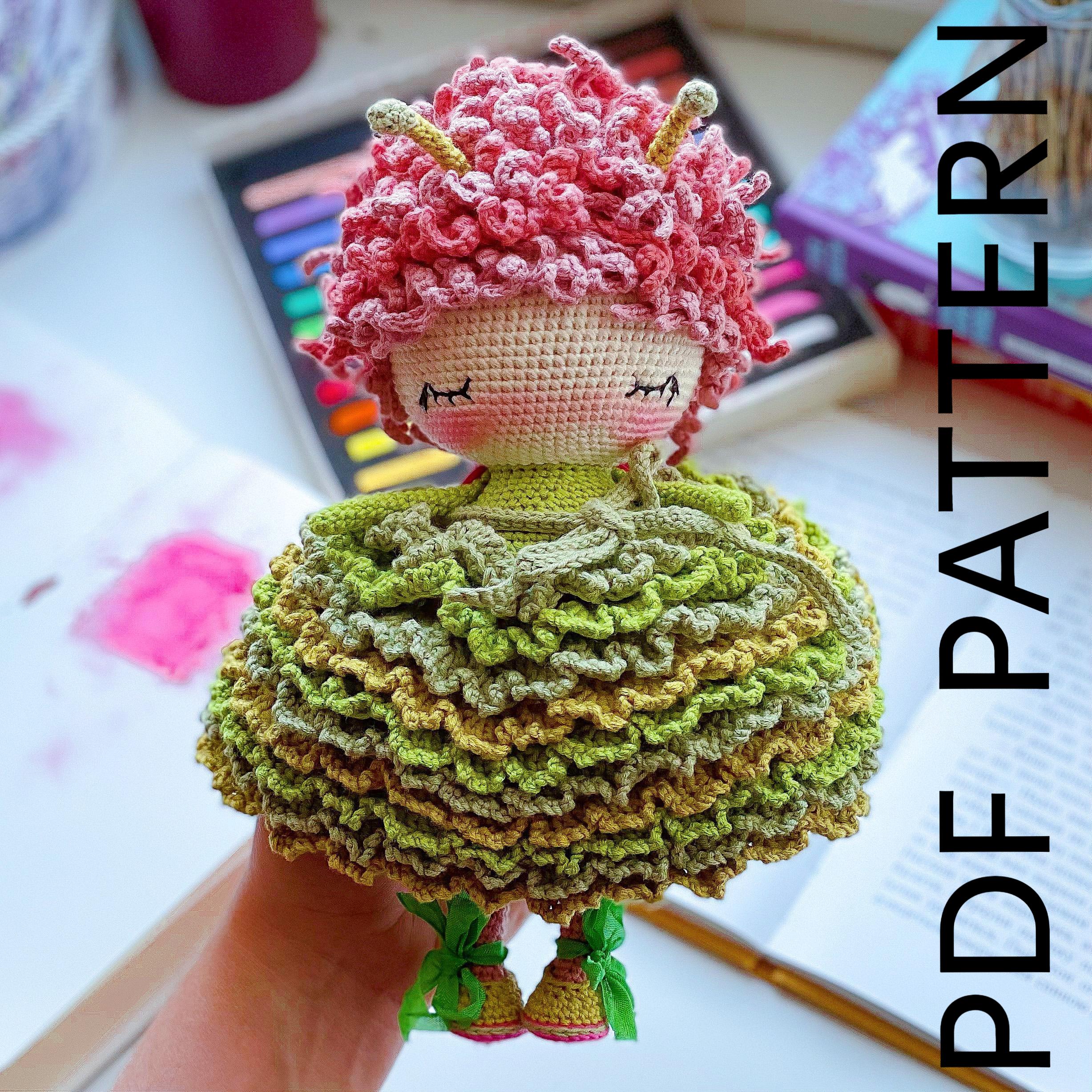 a crocheted doll is sitting on a table