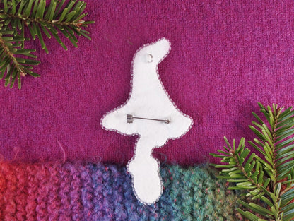 a white clock sitting on top of a purple blanket