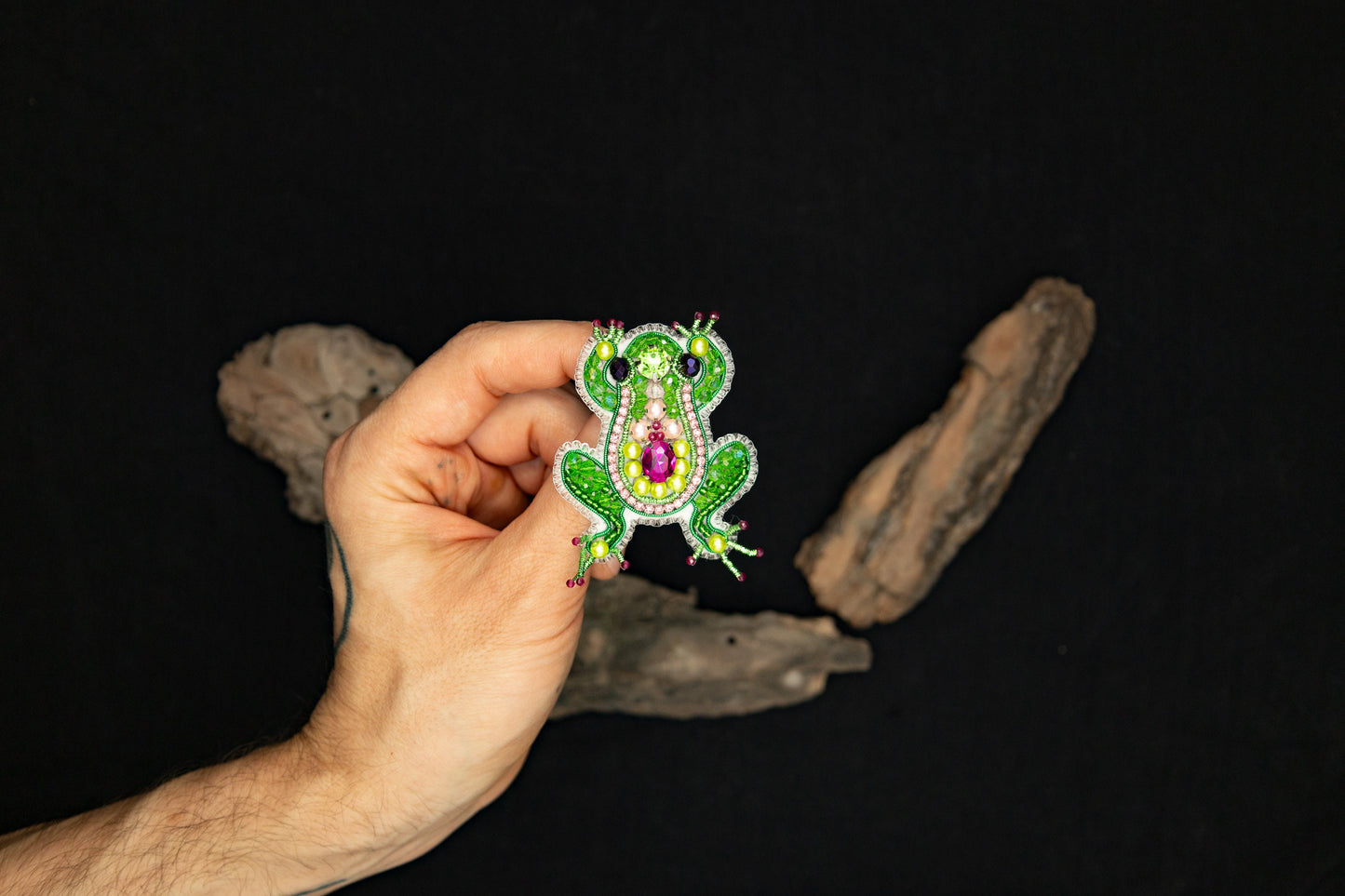 a person is holding a brooch in their hand