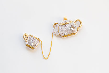 a pair of gold and white beaded purses