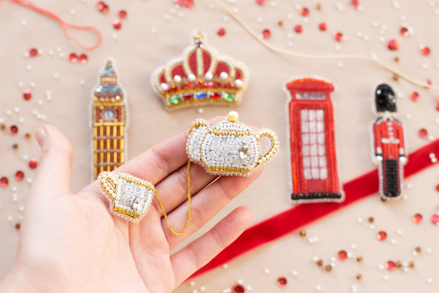 a hand is holding a miniature toy of a british royal guard