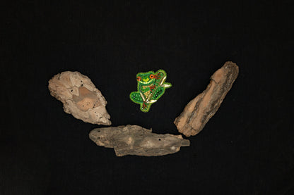 a piece of wood and a piece of rock on a black background