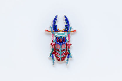 a colorful beaded cow head on a white background