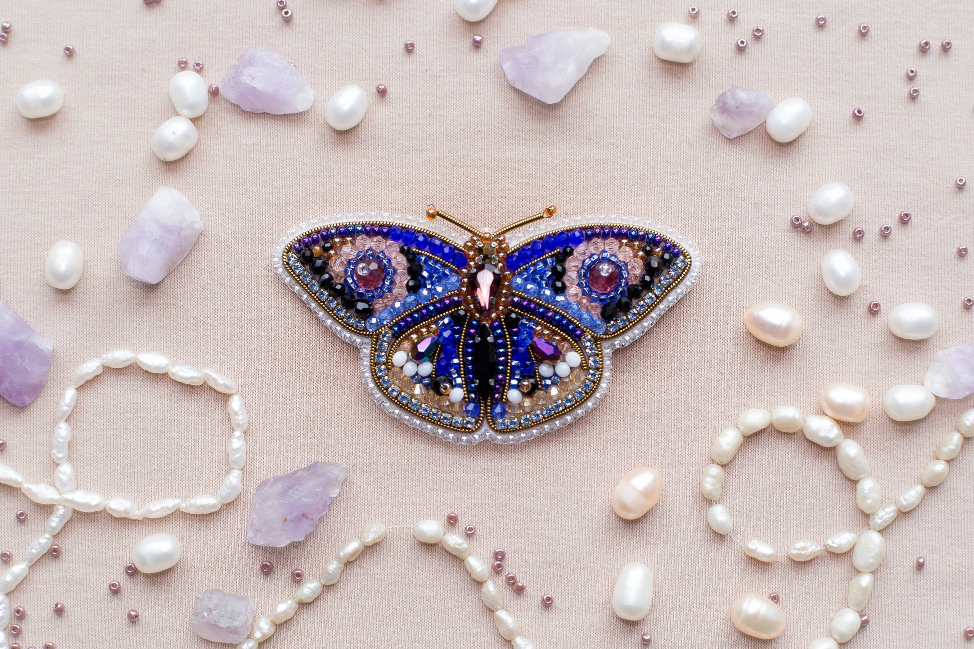 a butterfly brooch sitting on top of a table