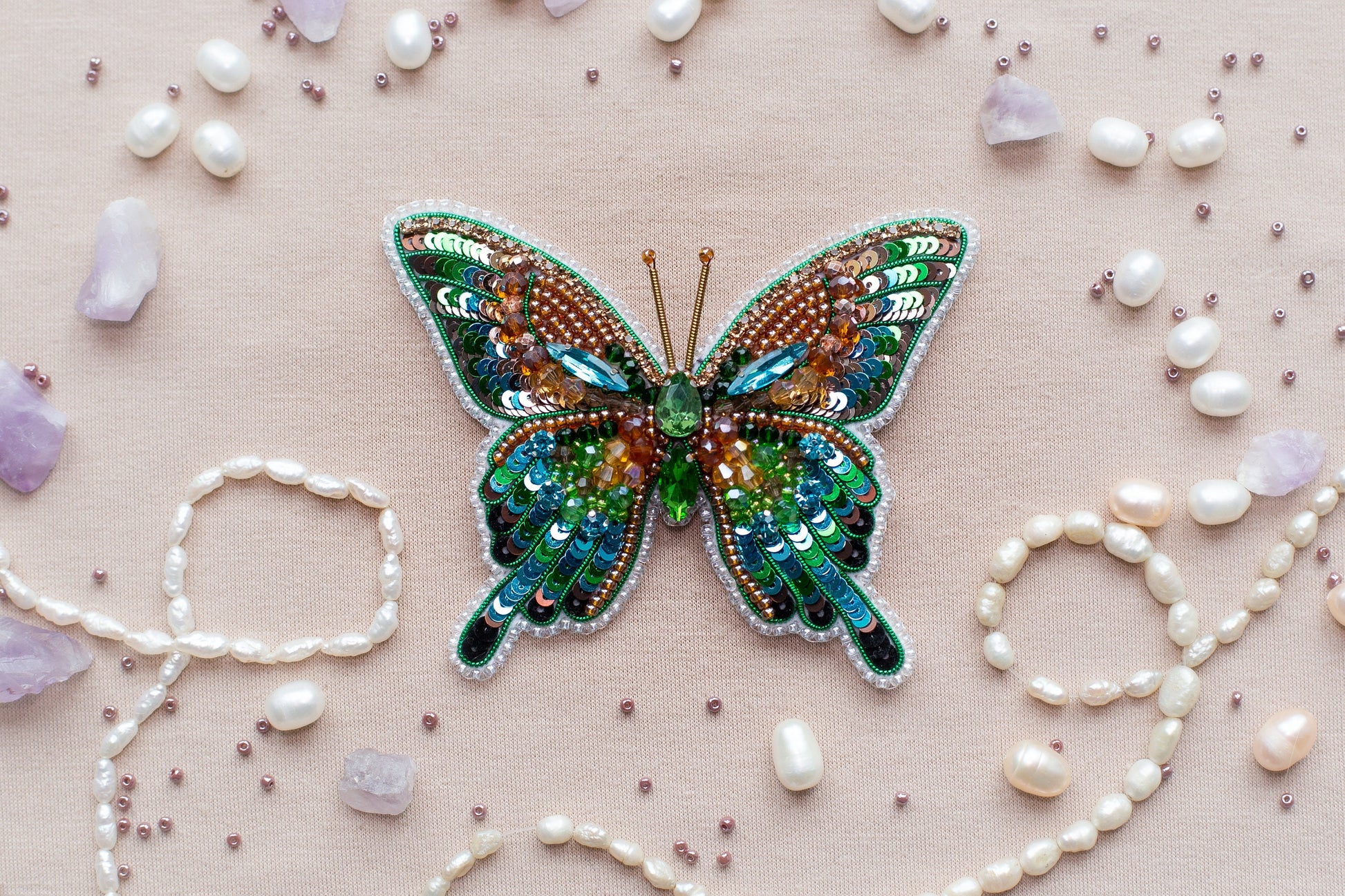 a butterfly brooch sitting on top of a table